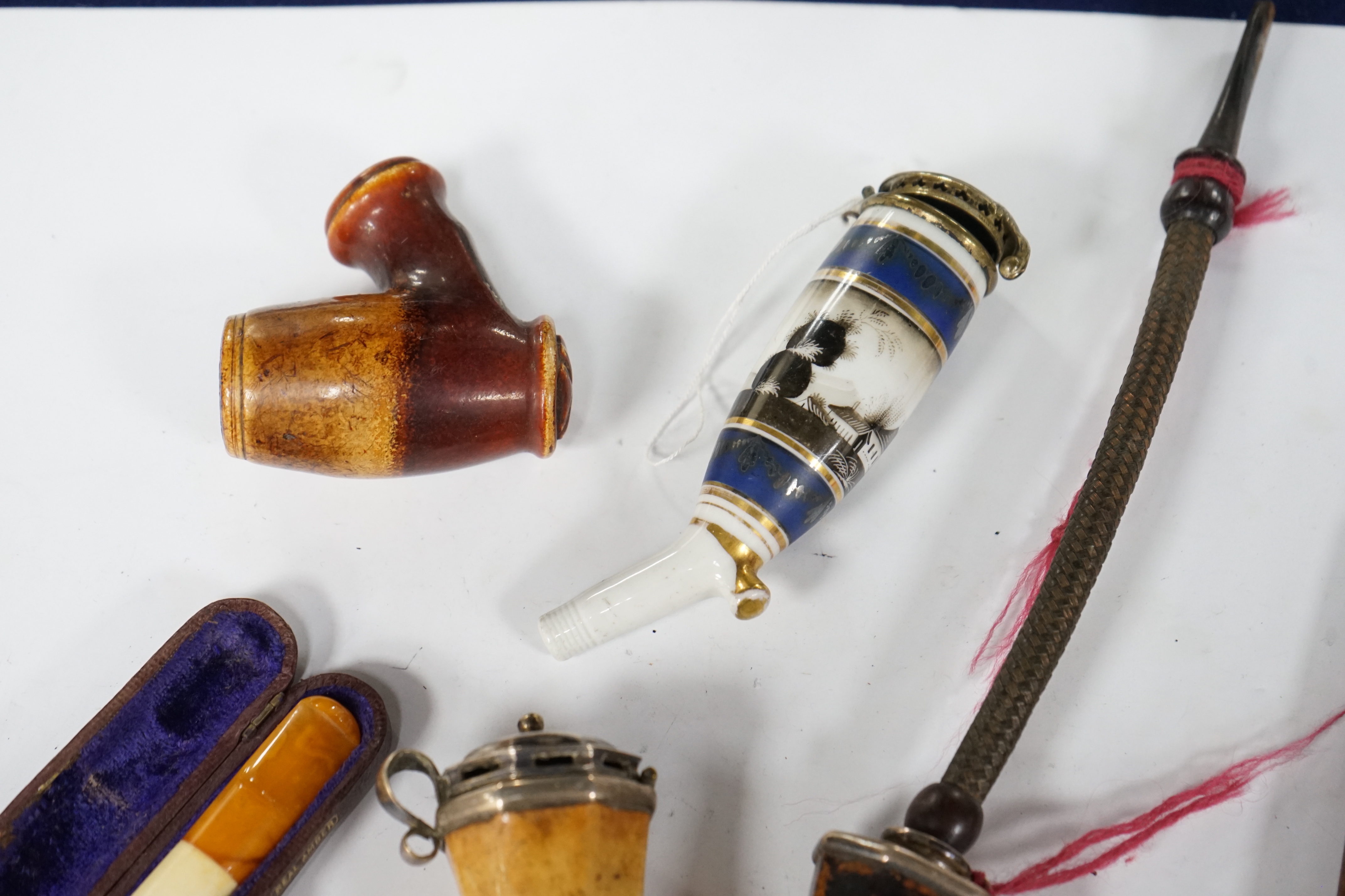 Seven pipes, three with amber mouthpieces, two cased and two without mouthpieces, longest cased pipe 20cm long